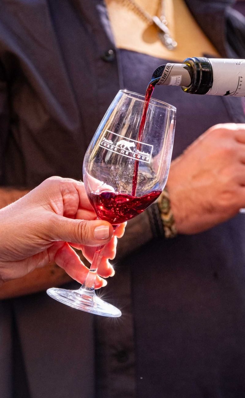 Une bouteille déverse du vin dans un verre lors d'une dégustation Flavien Photographe de reportage, reportage en Loire-Atlantique